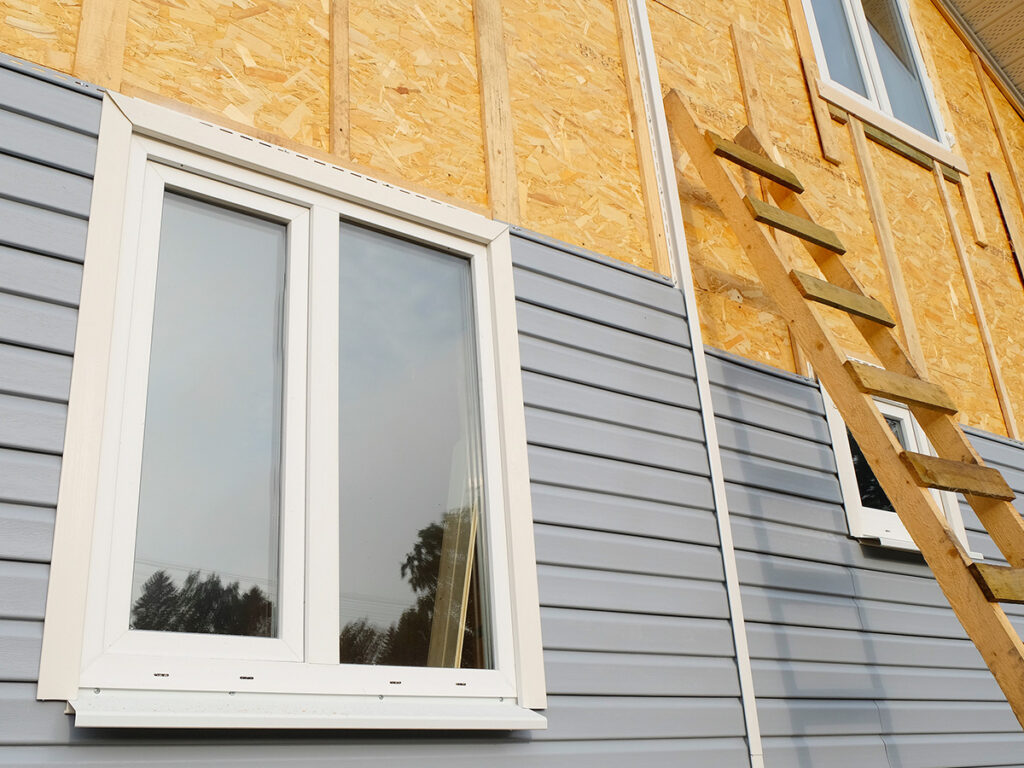 Installation of vinyl siding with Roofing for troops